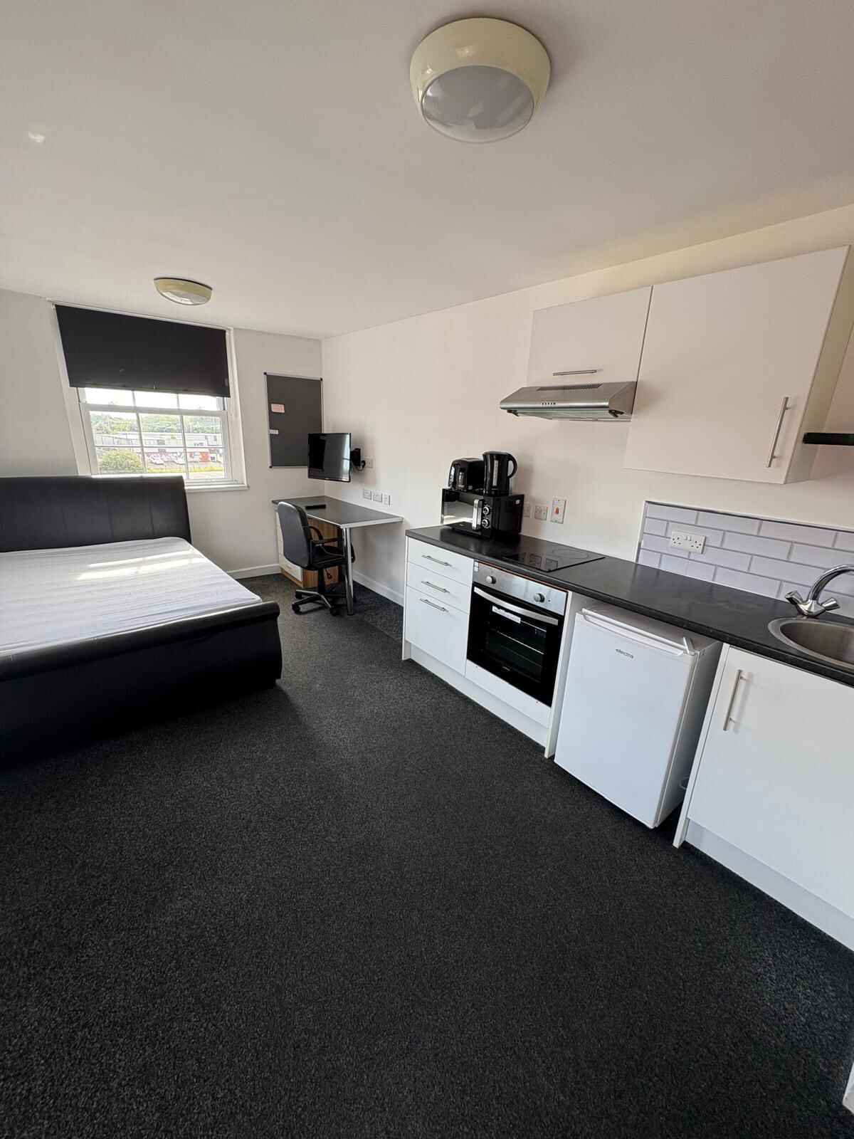 Interior staircase with wood floor and furniture in background